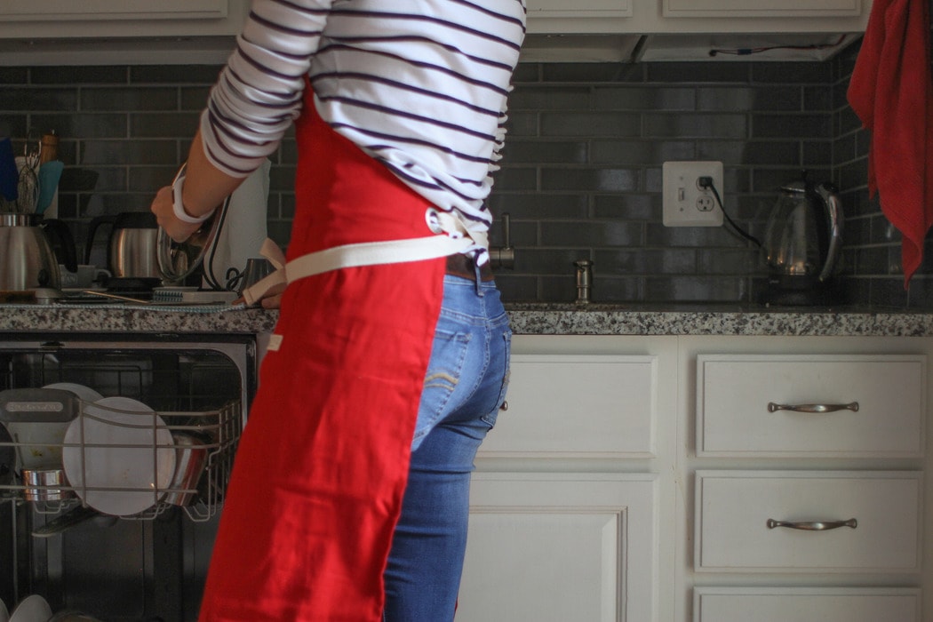 Kristen in a red apron.