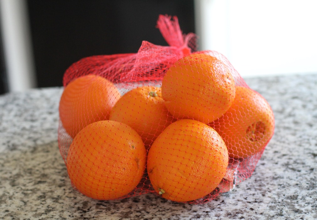 Mesh bag of oranges.