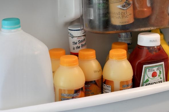 OJ bottles in fridge door