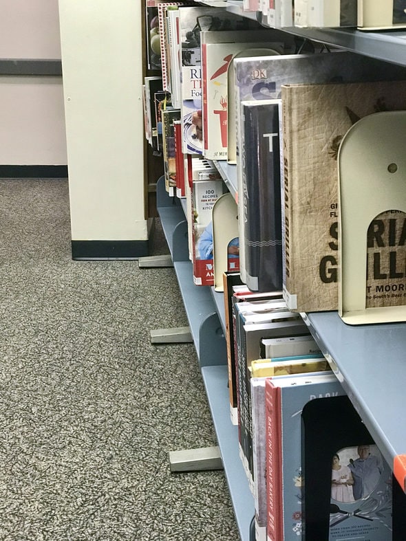 A library shelf full of cookbooks.