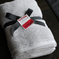 Gray hand towels tied with a black ribbon.