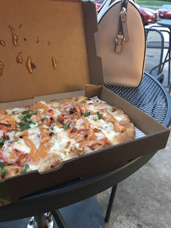 Panera chipotle pizza in a cardboard box.