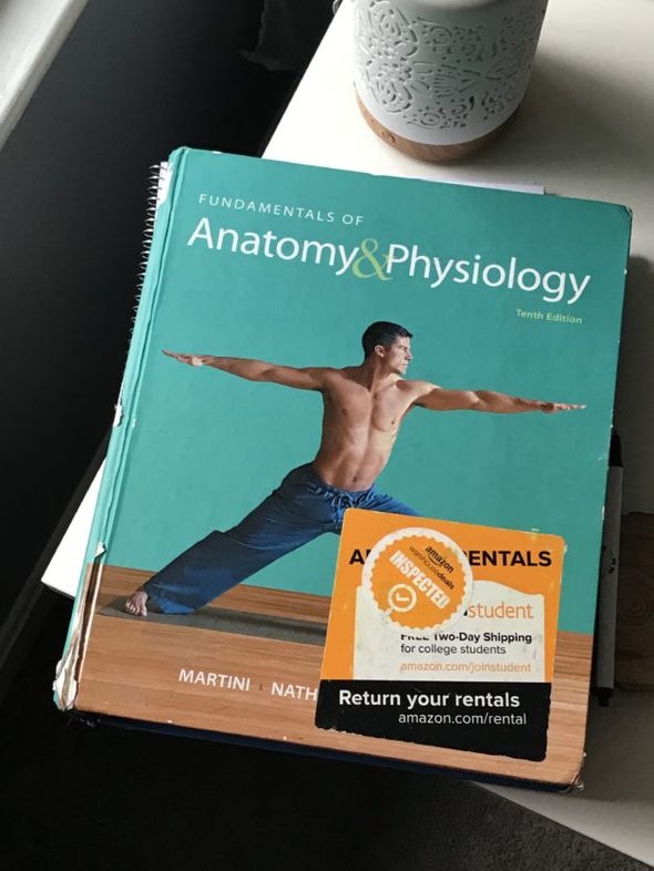 Anatomy and Physiology textbook with a green cover.