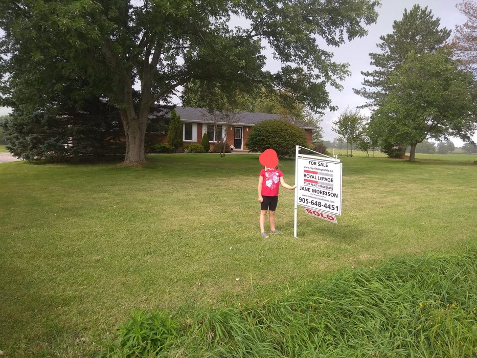 A home with a for-sale sign in the yard.