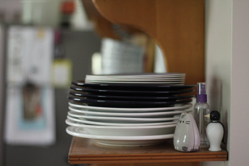 blue and white dinner plates stacked on a shelf.