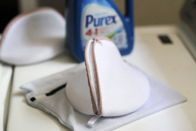 laundry bags in from of a bottle of Purex laundry detergent.