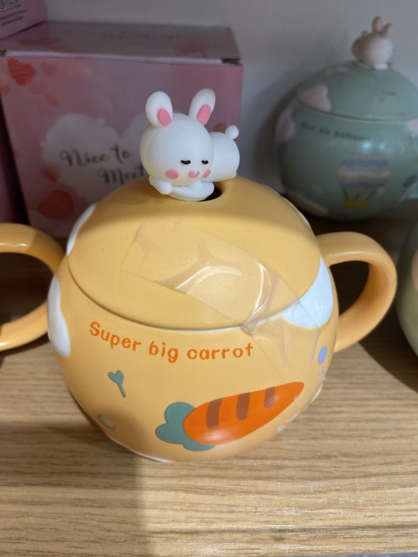 teapot with carrot on it.