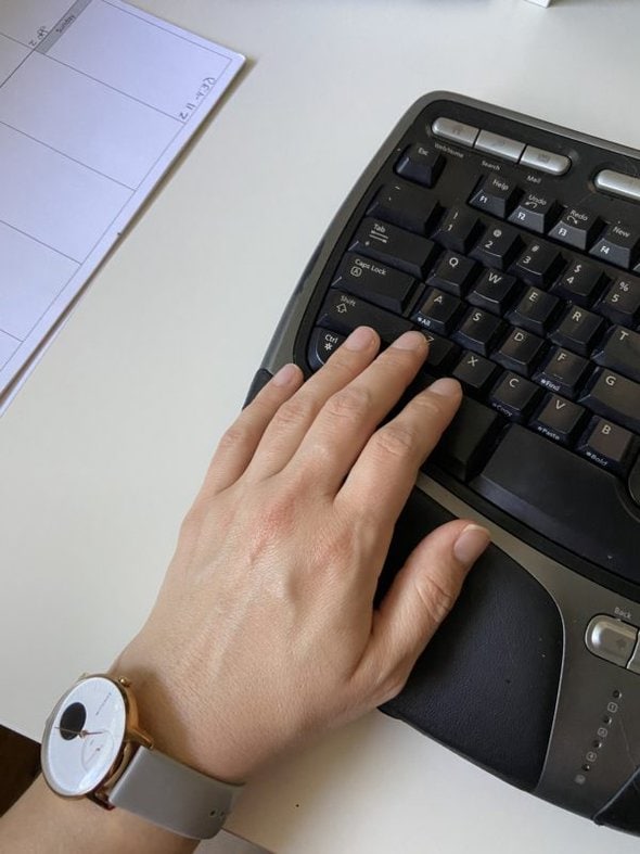 Kristen's hand on a keyboard.