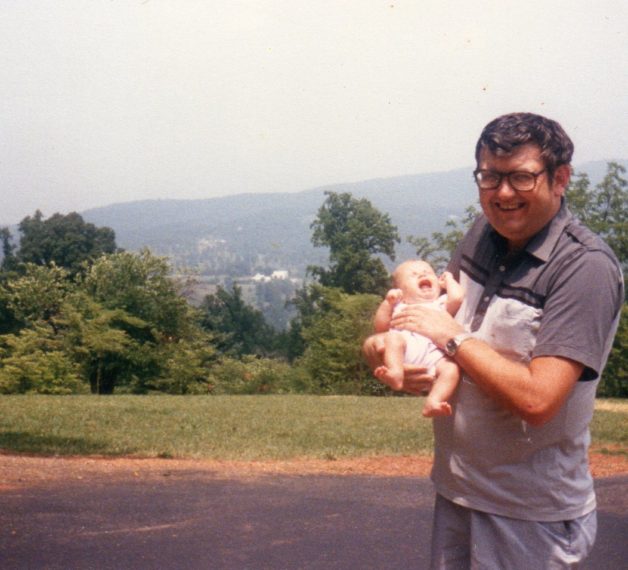 dad holding a baby.