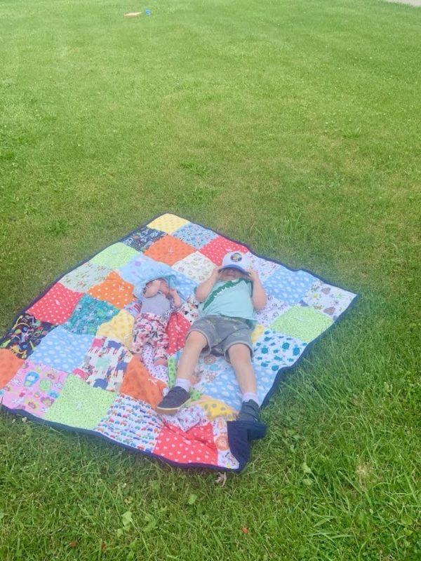 children on a picnic blanket.