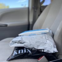 three packages on a car seat.