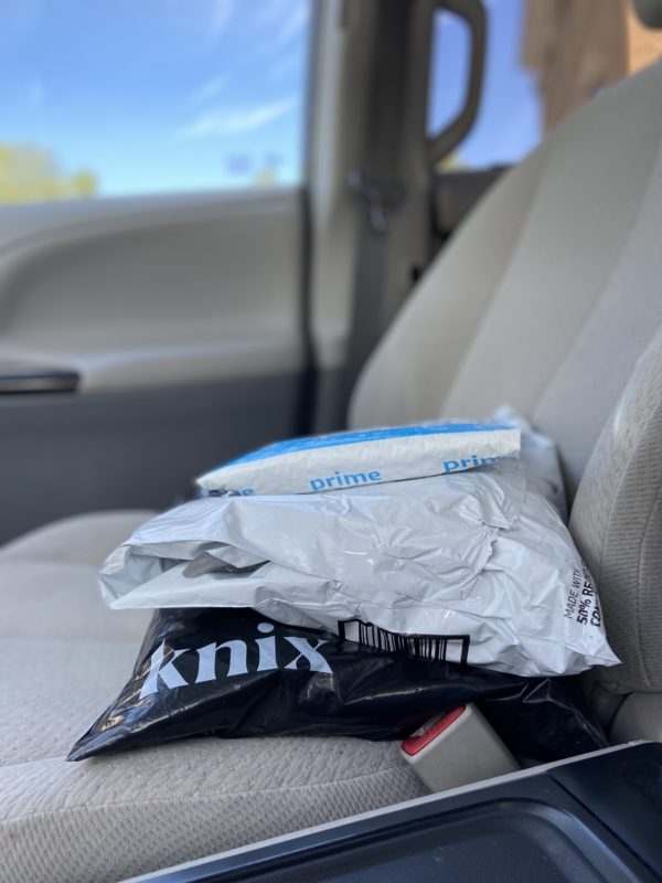 three packages on a car seat.