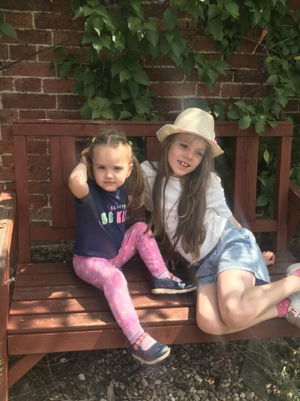 sisters on a bench.