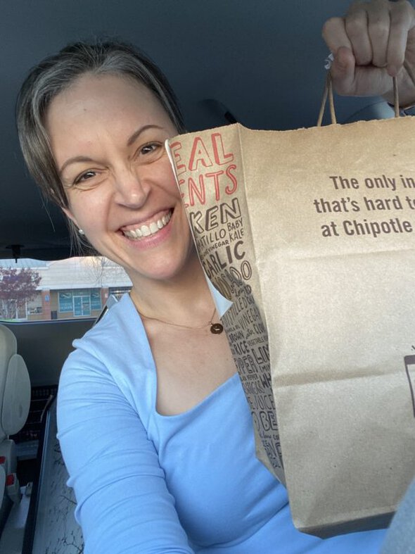 Kristen holding a chipotle bag.