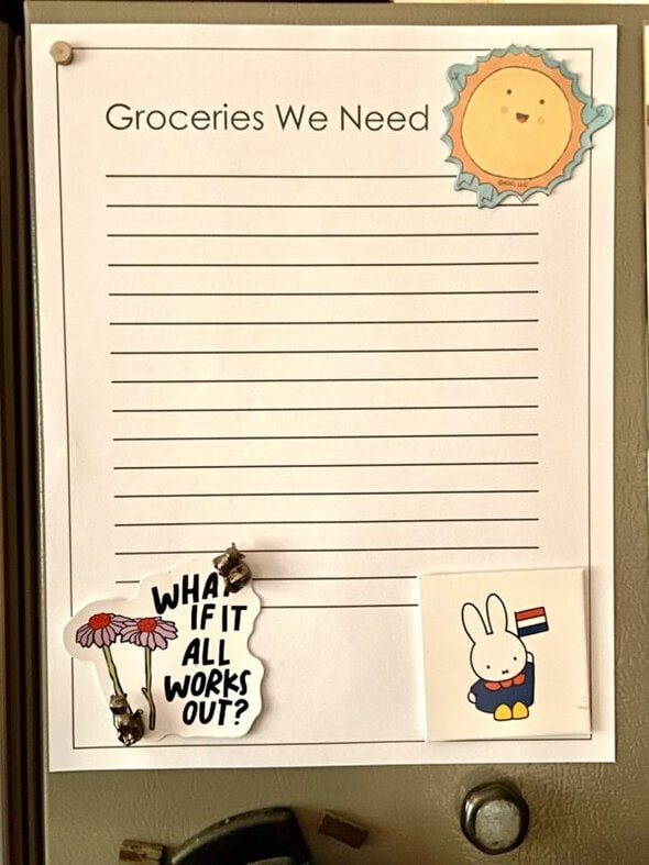 grocery list on side of fridge.